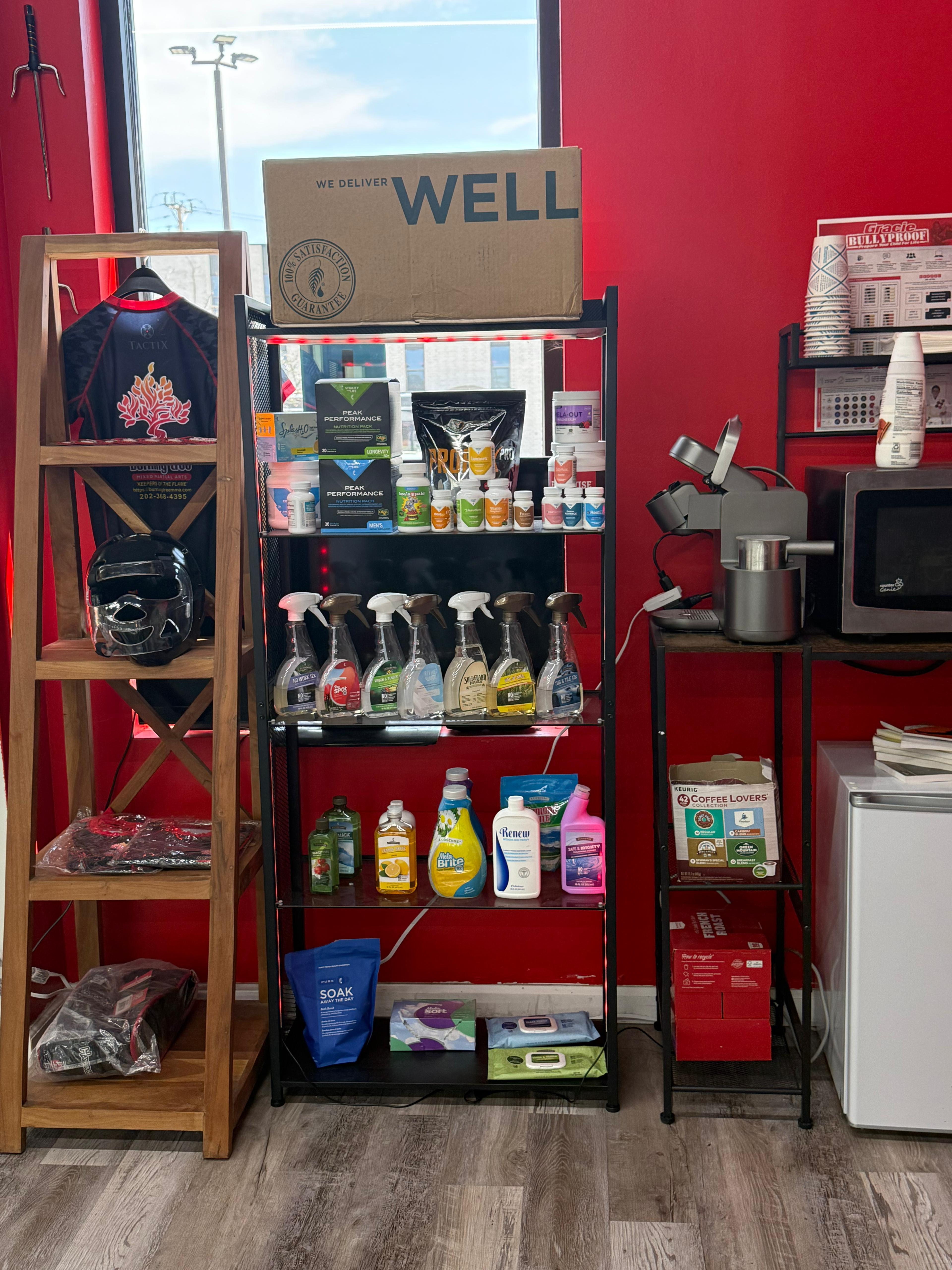 Display shelves of wellness and supplement products alongside Burning Tree MMA merchandise in the lobby