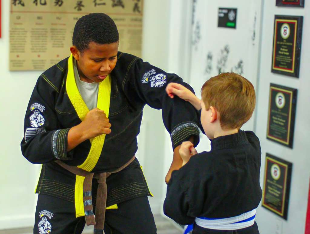 Young student practicing Muay Thai striking technique at Burning Tree MMA