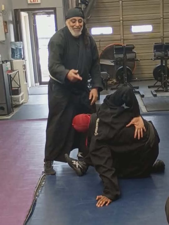 Instructor demonstrating a defense technique during Women's Defense class at Burning Tree MMA
